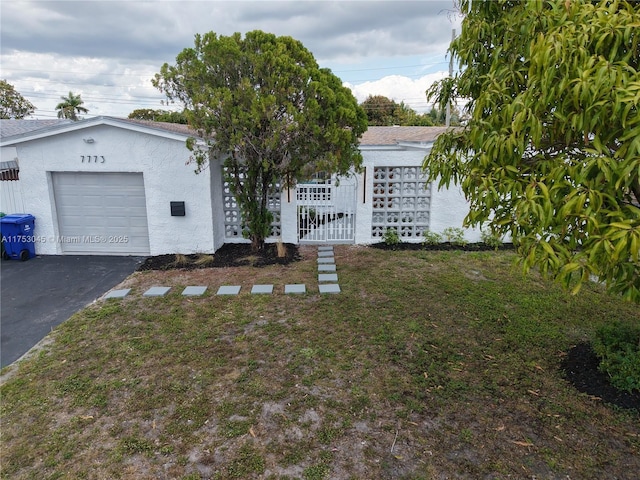 view of front of property with a garage, driveway, and stucco siding