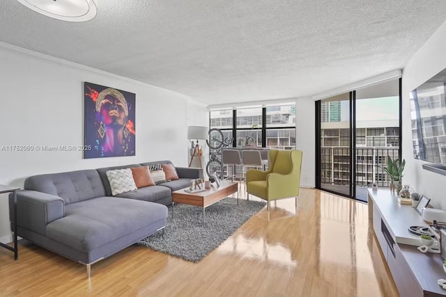 living area featuring a textured ceiling, wood finished floors, and floor to ceiling windows