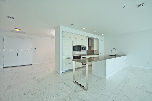 kitchen with black microwave, visible vents, marble finish floor, wall chimney exhaust hood, and dark countertops