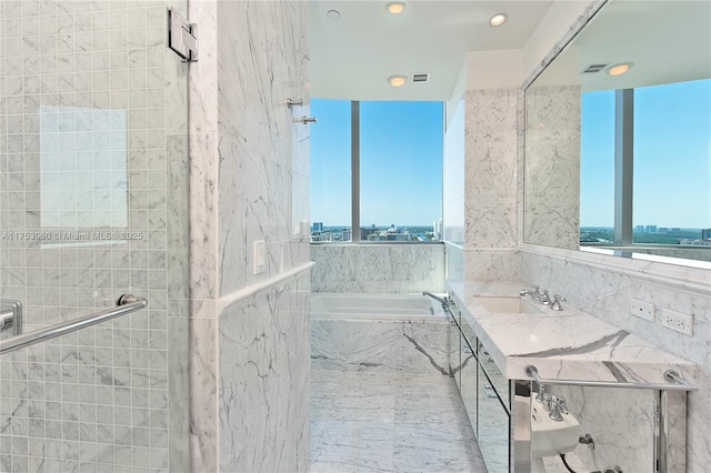 bathroom with visible vents, a sink, a shower stall, and a bath