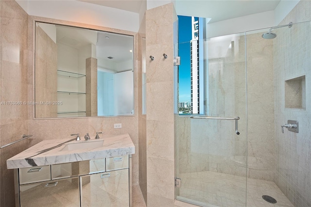 full bath featuring a stall shower, a sink, and backsplash