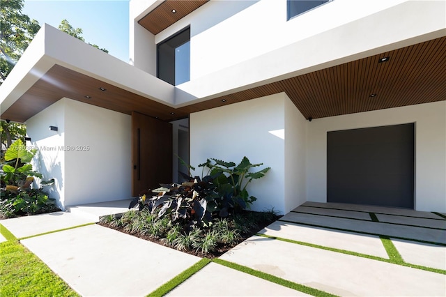 doorway to property with stucco siding