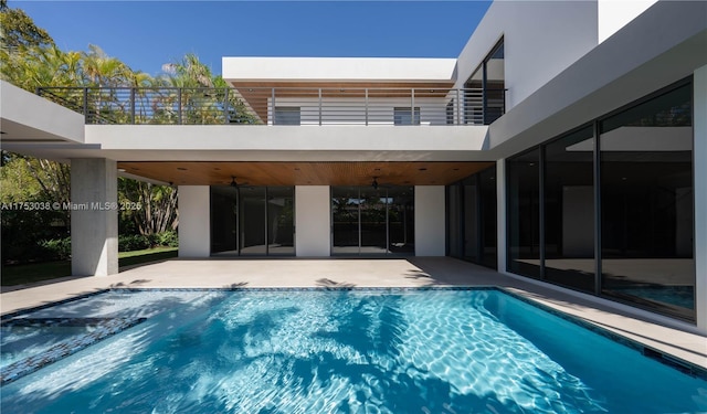 pool featuring ceiling fan and a patio area