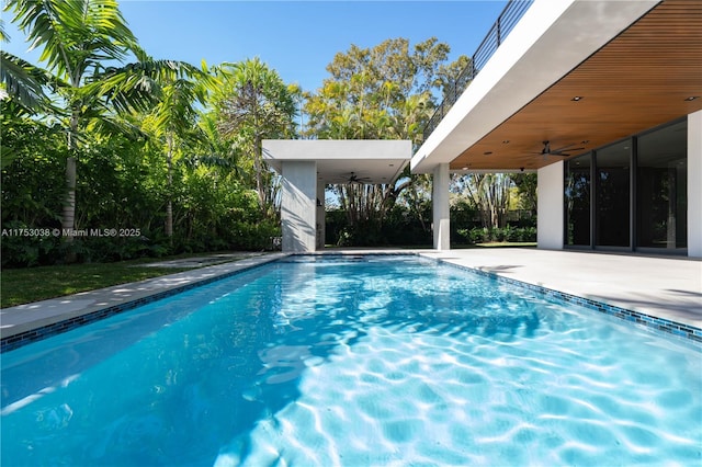 outdoor pool featuring a patio area and ceiling fan