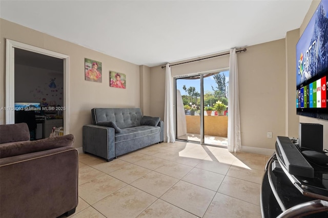 living area with light tile patterned floors and baseboards