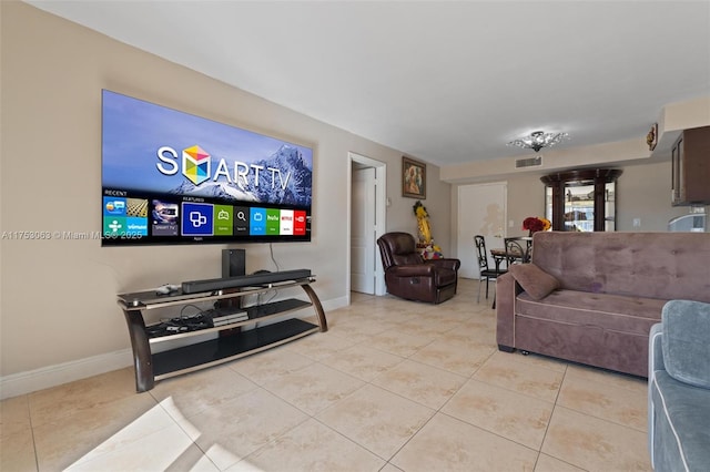 living area featuring visible vents, baseboards, and light tile patterned floors