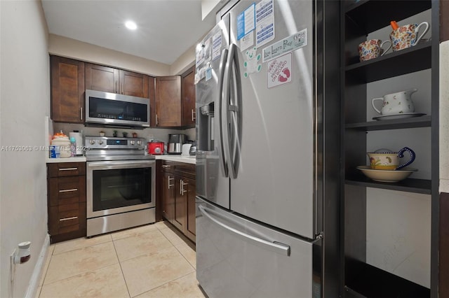 kitchen featuring light tile patterned floors, stainless steel appliances, open shelves, and light countertops