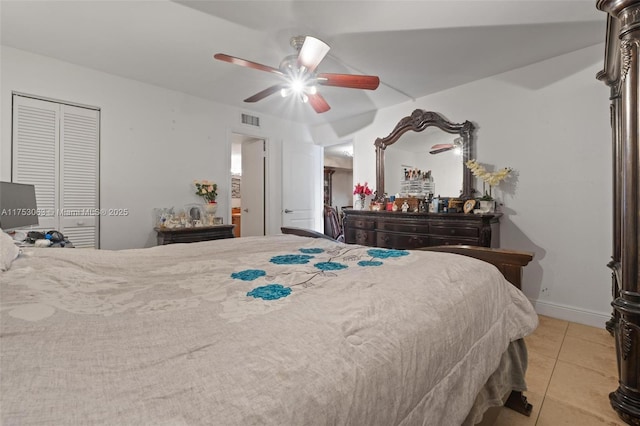 bedroom with baseboards, visible vents, a ceiling fan, a closet, and light tile patterned flooring