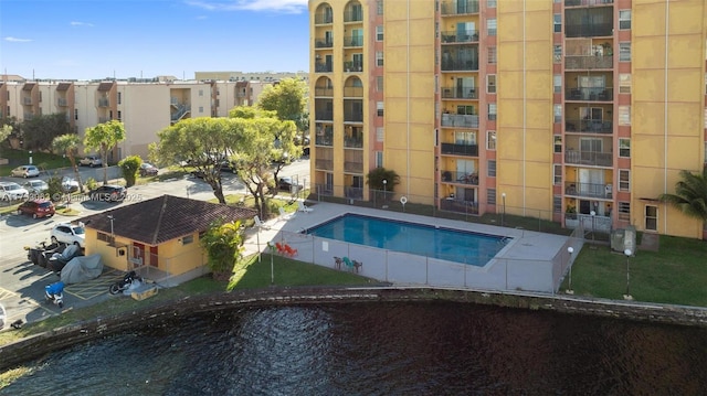 pool featuring a water view and fence