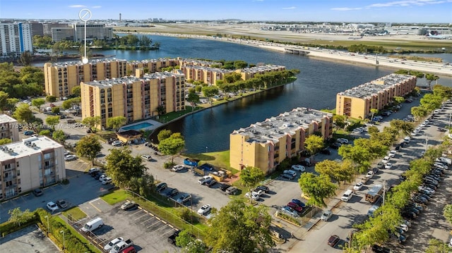 birds eye view of property with a water view and a city view