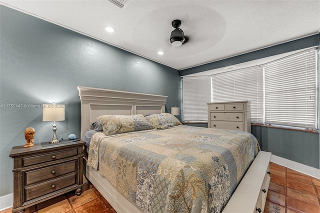 bedroom with ceiling fan, baseboards, a textured ceiling, and recessed lighting