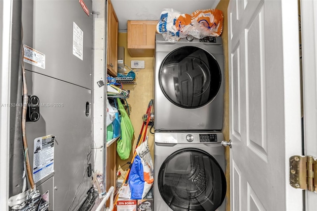 laundry room featuring laundry area and stacked washer / drying machine