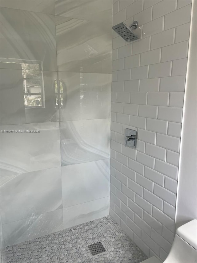bathroom with tiled shower