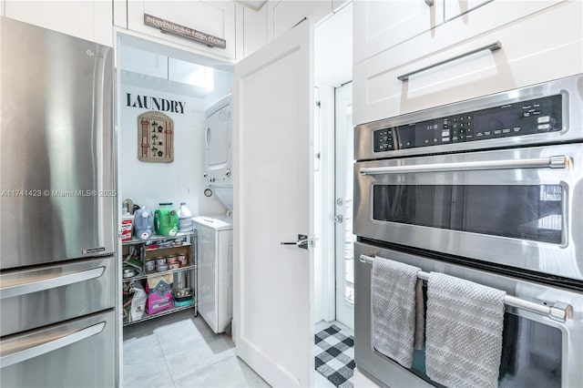 kitchen with white cabinetry, stainless steel appliances, and light tile patterned flooring