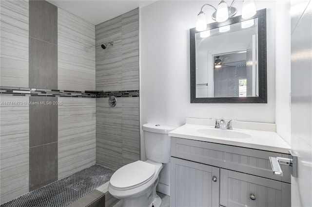 bathroom featuring a shower stall, vanity, and toilet