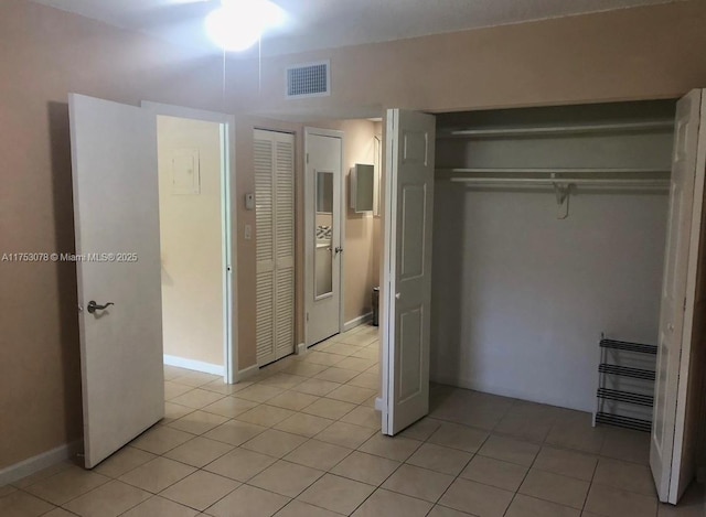 unfurnished bedroom with visible vents, baseboards, and light tile patterned floors