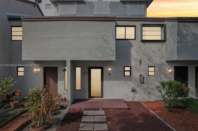 entrance to property with stucco siding