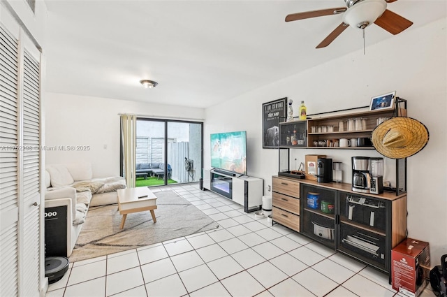 living area featuring ceiling fan and light tile patterned floors