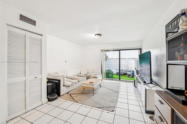 unfurnished living room with light tile patterned floors and visible vents