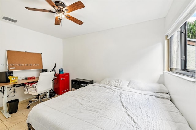 bedroom with a ceiling fan, visible vents, and light tile patterned floors