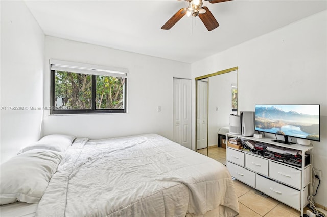 bedroom featuring a ceiling fan, a closet, and light tile patterned flooring