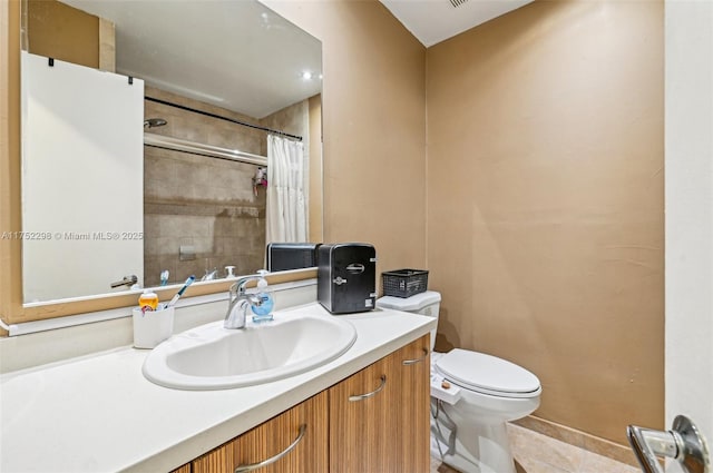 bathroom with toilet, tile patterned flooring, vanity, and a tile shower