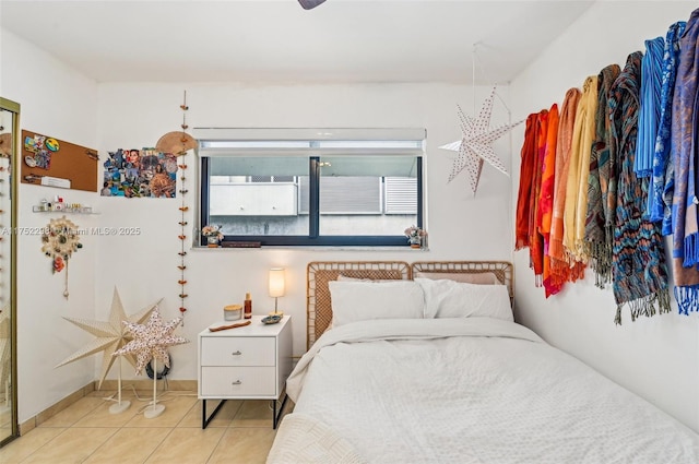 tiled bedroom featuring baseboards