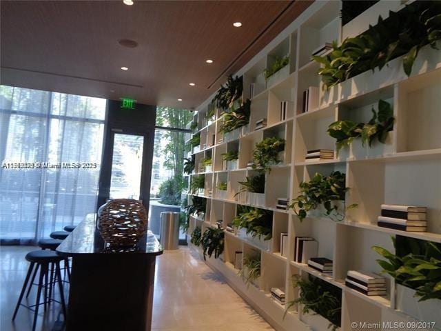 interior space with tile patterned flooring, expansive windows, and recessed lighting