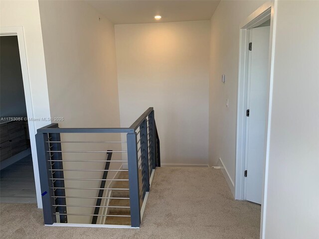 hall featuring recessed lighting, baseboards, an upstairs landing, and carpet