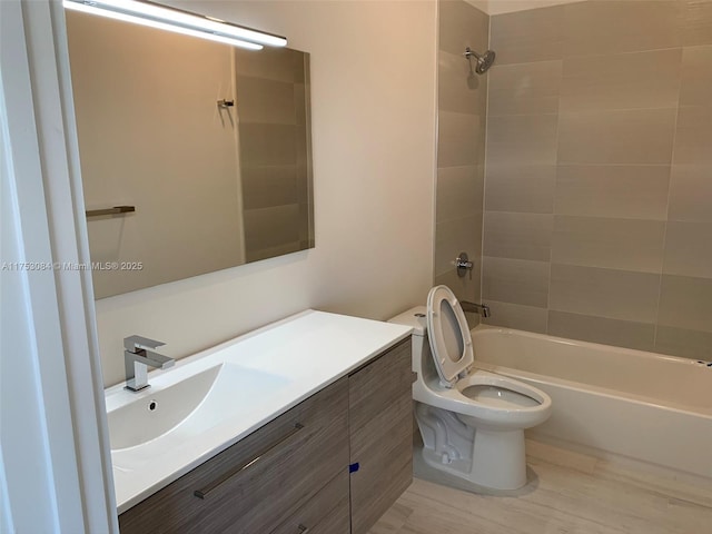 full bathroom featuring toilet, bathing tub / shower combination, and vanity