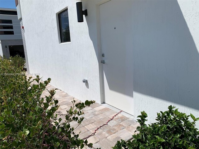 property entrance featuring stucco siding