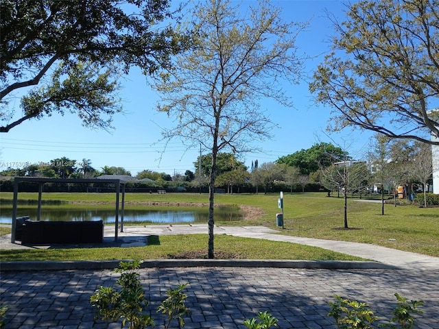 view of property's community with a water view and a yard