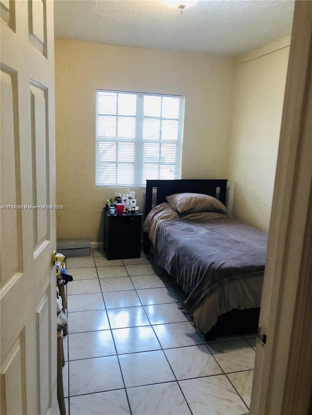 bedroom with light tile patterned floors