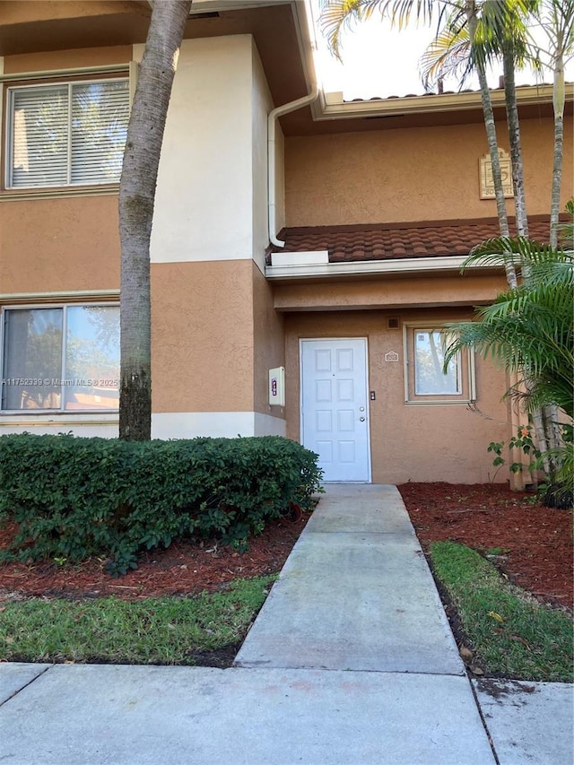 doorway to property with stucco siding