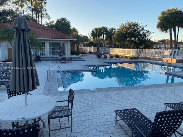 pool featuring a patio area and fence