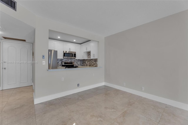 interior space featuring recessed lighting, visible vents, and baseboards