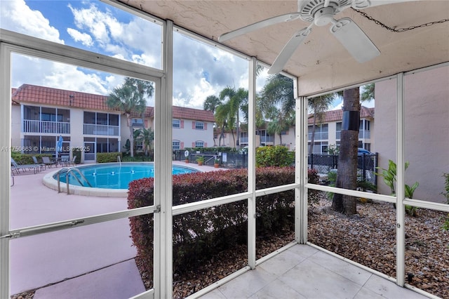 unfurnished sunroom featuring ceiling fan