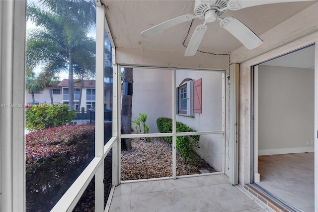 unfurnished sunroom with a ceiling fan