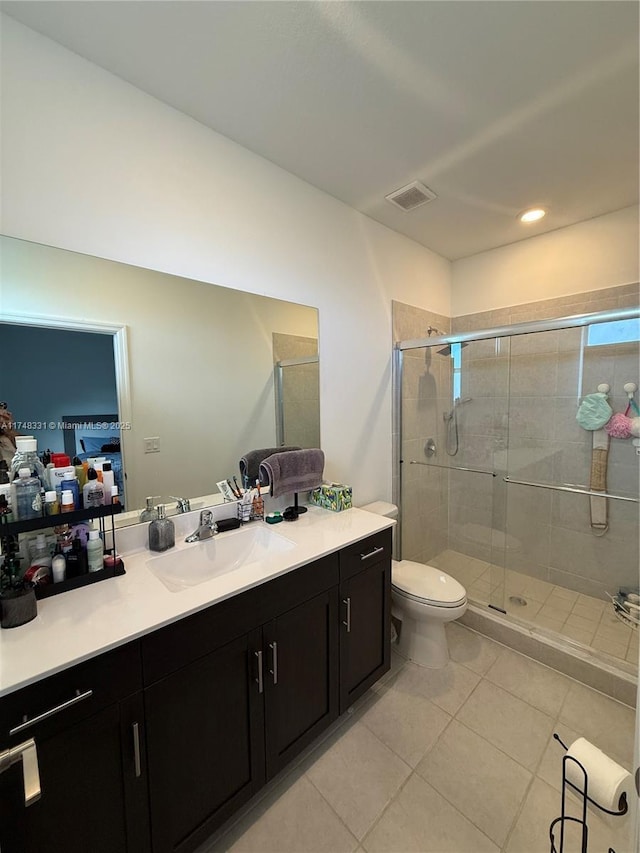 ensuite bathroom with visible vents, a stall shower, connected bathroom, vanity, and tile patterned flooring