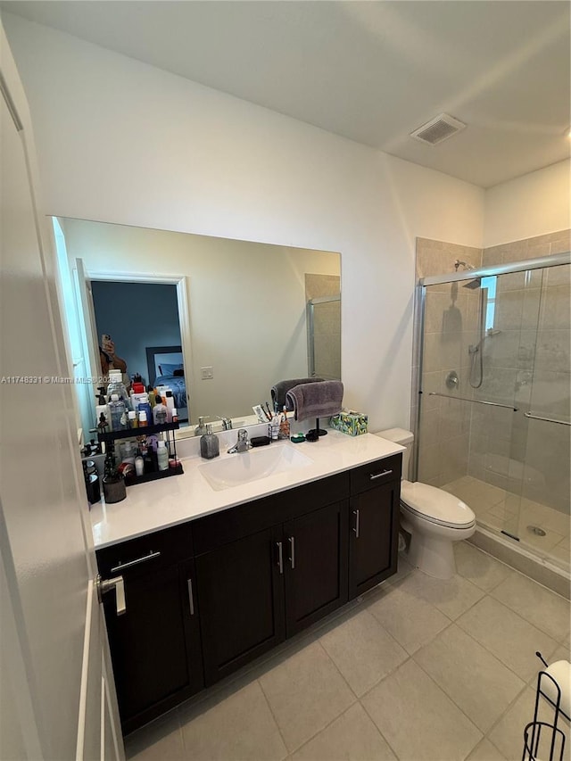 ensuite bathroom with visible vents, vanity, toilet, and tile patterned floors