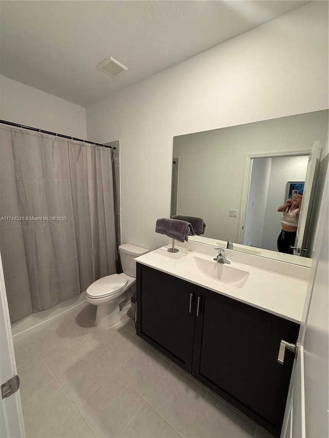 bathroom featuring curtained shower, visible vents, toilet, vanity, and tile patterned flooring