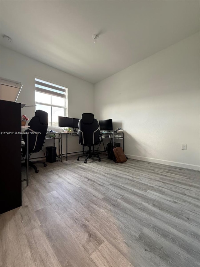 office space with light wood-style flooring and baseboards