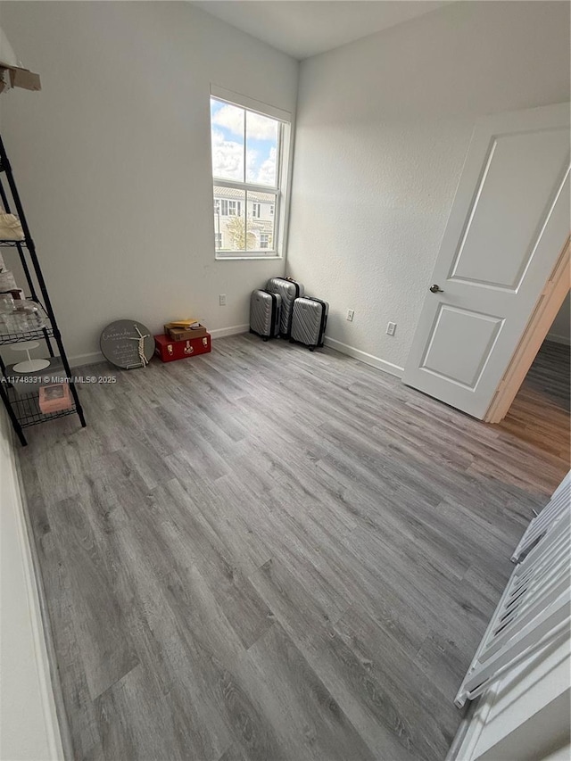 unfurnished bedroom featuring light wood-type flooring and baseboards