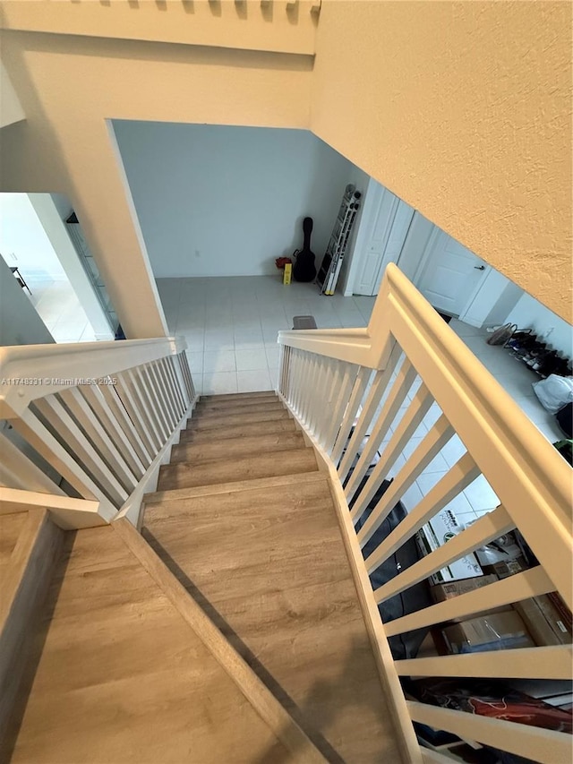 staircase with wood finished floors