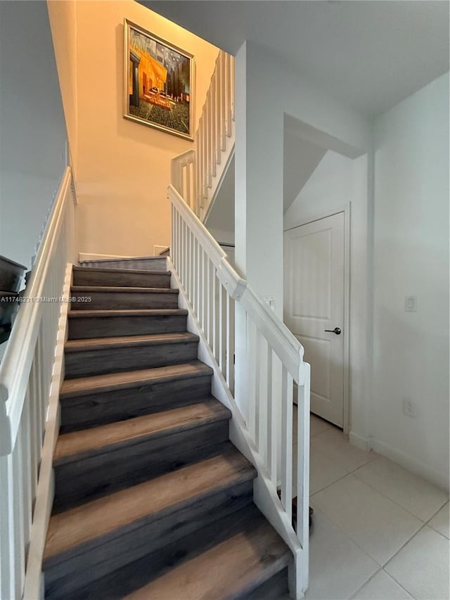 stairway with tile patterned flooring