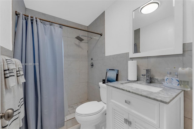full bathroom featuring vanity, tile walls, a tile shower, and toilet