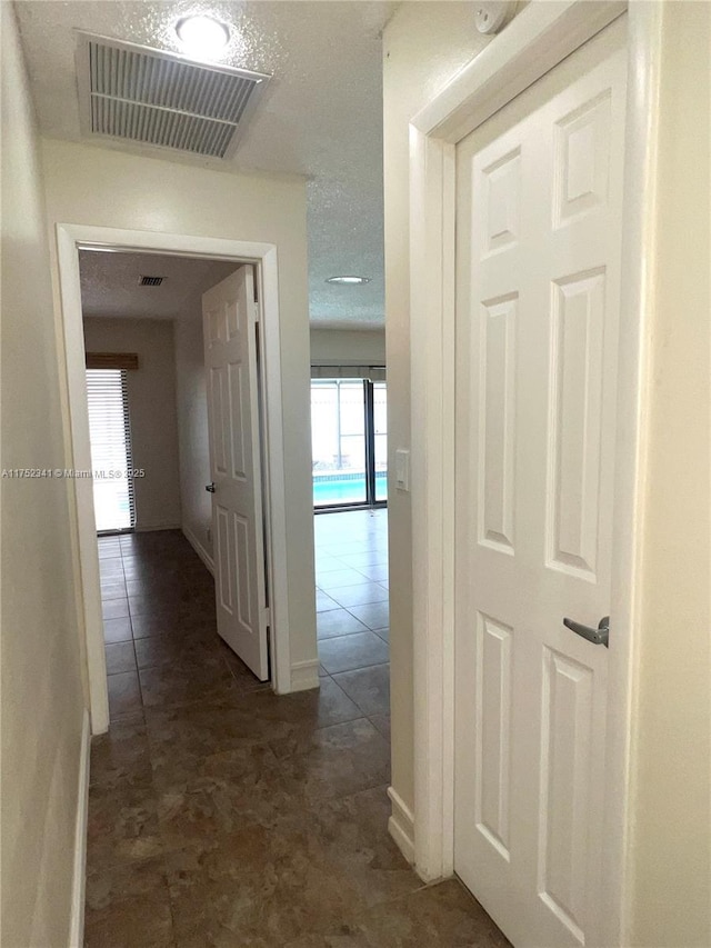 hallway featuring a healthy amount of sunlight and visible vents