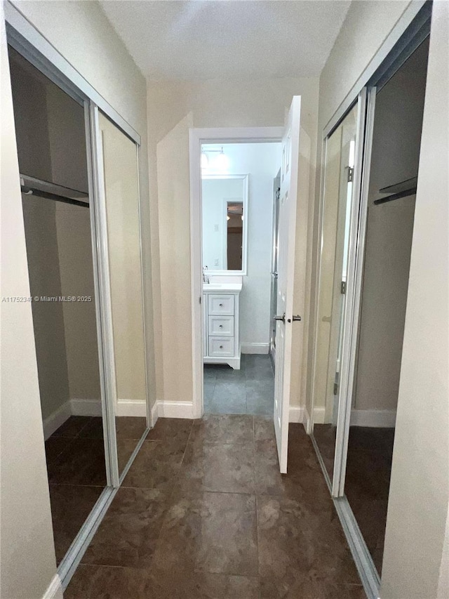 hallway with tile patterned flooring
