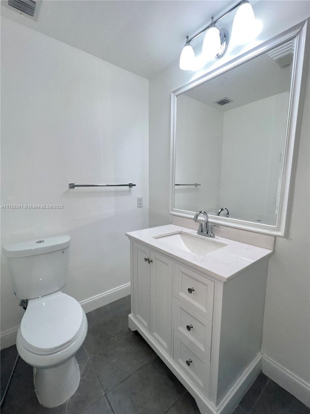 bathroom with toilet, baseboards, and visible vents