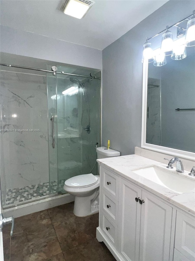 bathroom with toilet, vanity, visible vents, and a marble finish shower